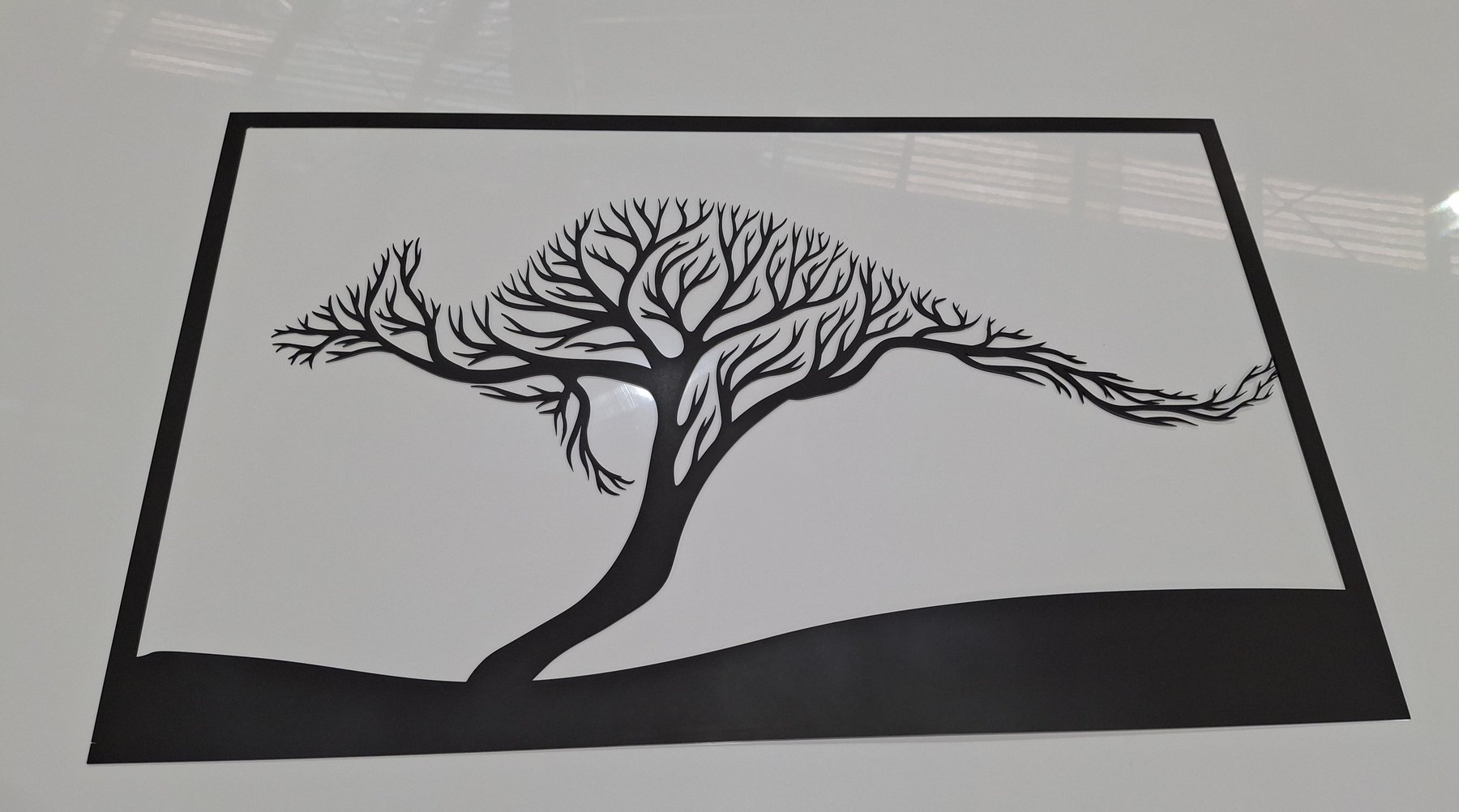 Laser cut metal wall art of a windswept tree